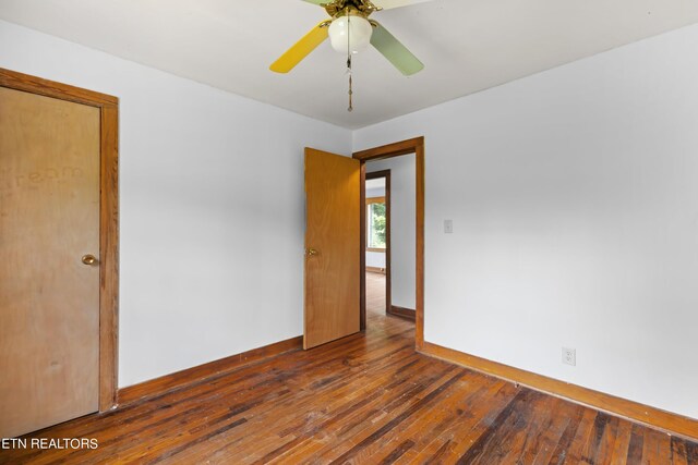 empty room featuring wood-type flooring and ceiling fan