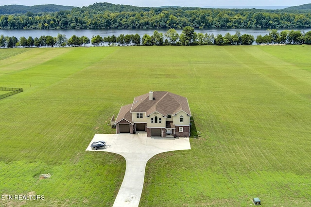 birds eye view of property with a water view and a rural view