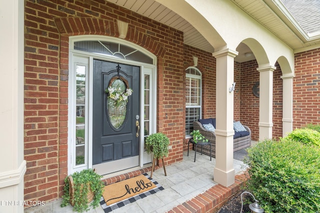 entrance to property featuring a porch