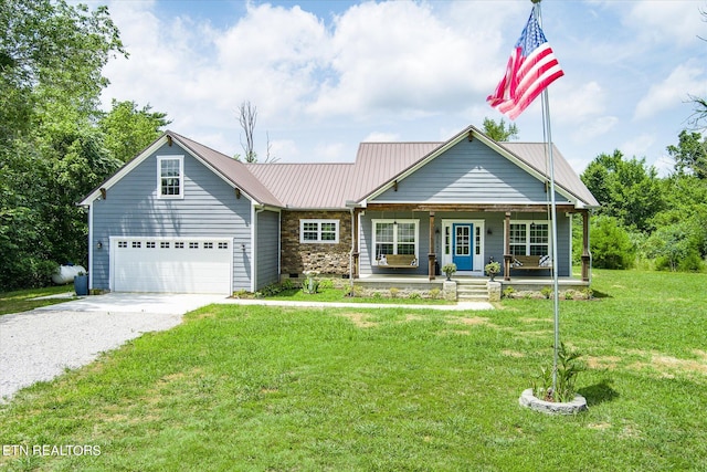 view of front of home featuring a porch, a garage, and a front lawn