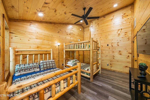 bedroom featuring dark hardwood / wood-style flooring, lofted ceiling, wooden walls, and wood ceiling