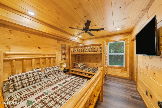 bedroom with dark wood-type flooring, wooden ceiling, and wooden walls