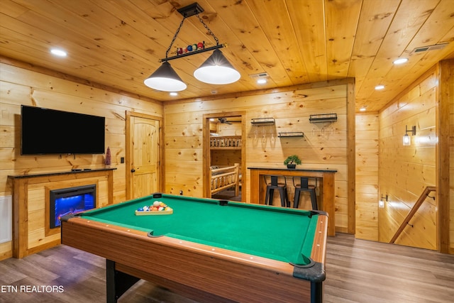 game room with hardwood / wood-style flooring, wood ceiling, and wooden walls