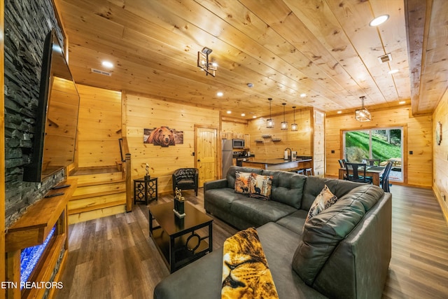 living room with wooden walls, dark hardwood / wood-style flooring, and wooden ceiling