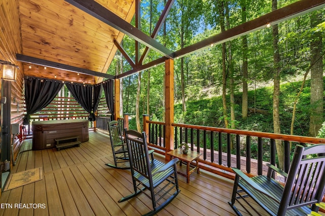 wooden terrace with a hot tub