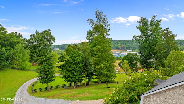 view of community with a yard and a rural view