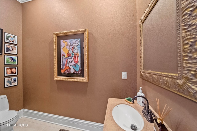 bathroom with vanity, tile patterned flooring, and toilet