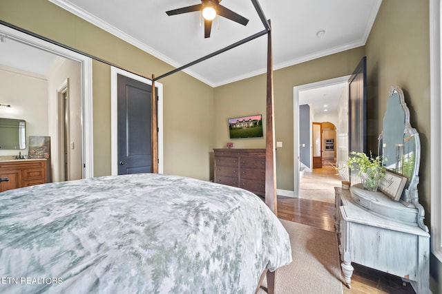 bedroom featuring crown molding, hardwood / wood-style floors, sink, and ceiling fan