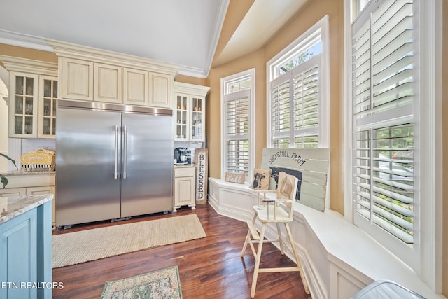 kitchen featuring crown molding, built in refrigerator, wood-type flooring, and a wealth of natural light