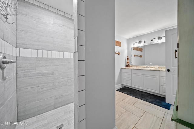 bathroom featuring tile patterned flooring and vanity