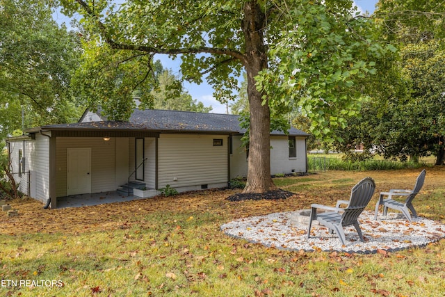 back of property with a patio and a lawn