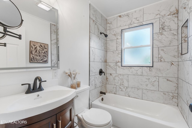 full bathroom with toilet, vanity, and tiled shower / bath