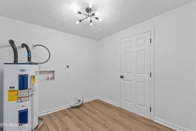 clothes washing area with hookup for an electric dryer, light wood-type flooring, water heater, and washer hookup