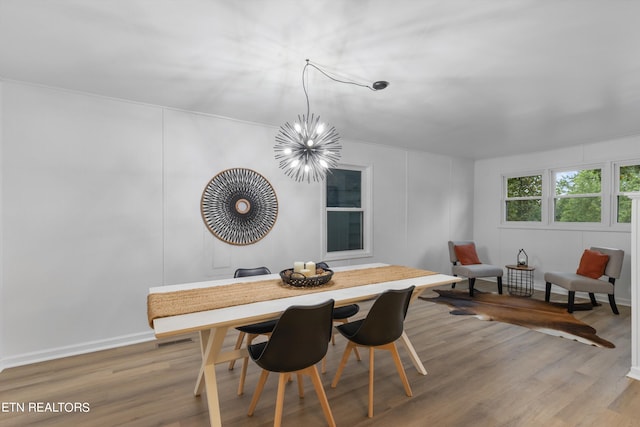 dining space featuring an inviting chandelier and wood-type flooring