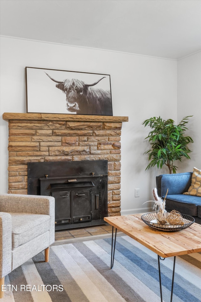 carpeted living room featuring a fireplace and crown molding