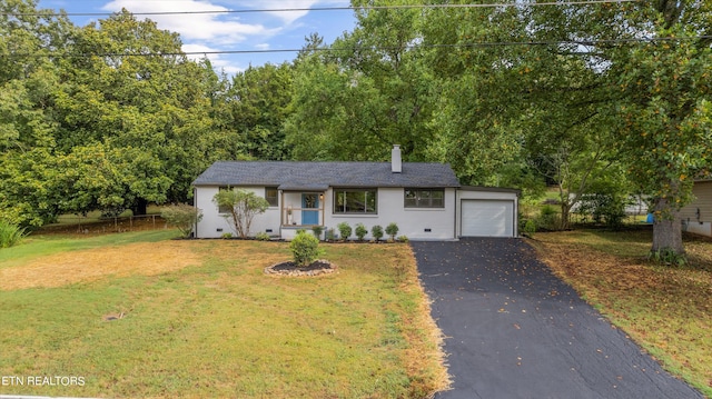 view of front of home with a garage and a front lawn