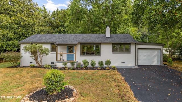 view of front of house featuring a garage and a front yard