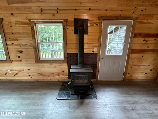 room details with a wood stove and hardwood / wood-style flooring