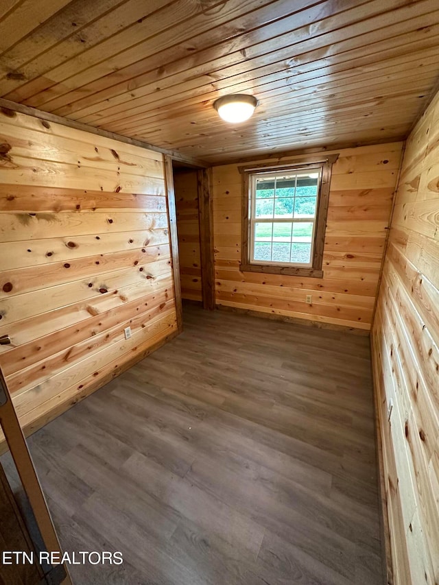 additional living space featuring hardwood / wood-style flooring, wooden walls, and wooden ceiling