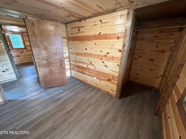 interior space featuring hardwood / wood-style flooring, wood ceiling, and wooden walls