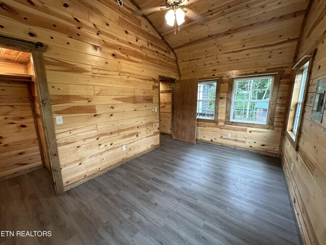 unfurnished room with hardwood / wood-style floors, vaulted ceiling, and wood ceiling