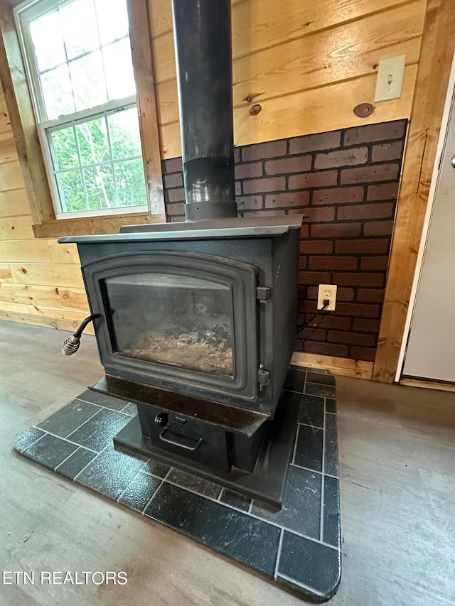 interior details featuring wood walls and a wood stove