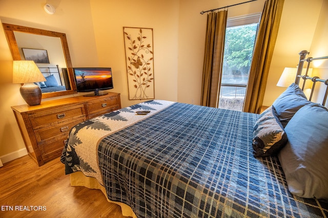 bedroom with hardwood / wood-style floors