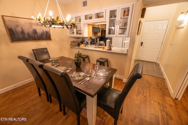 dining room featuring an inviting chandelier and hardwood / wood-style floors