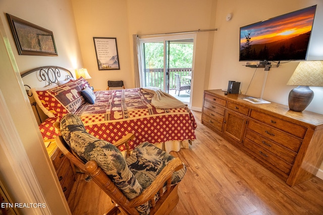 bedroom with access to outside and light hardwood / wood-style flooring