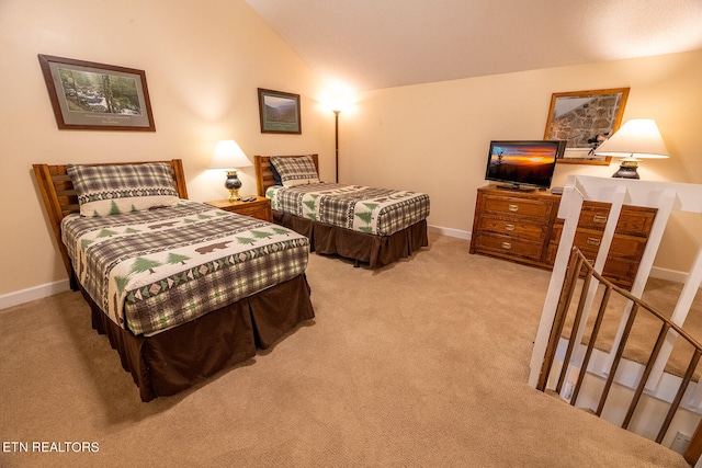 carpeted bedroom with vaulted ceiling