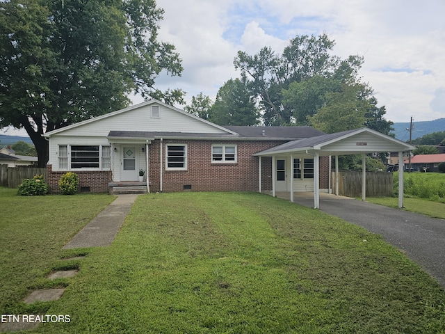 ranch-style house with a carport and a front lawn