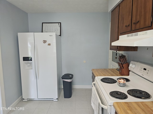 kitchen with light tile patterned flooring and white appliances