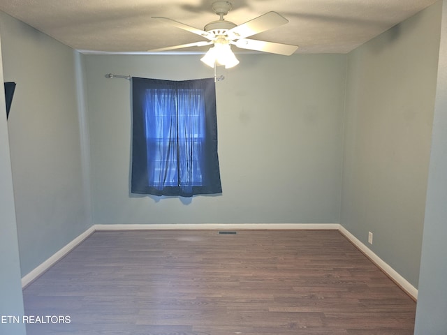 empty room featuring hardwood / wood-style flooring, a textured ceiling, and ceiling fan