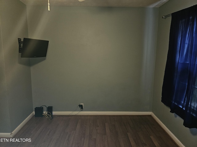 spare room featuring dark wood-type flooring