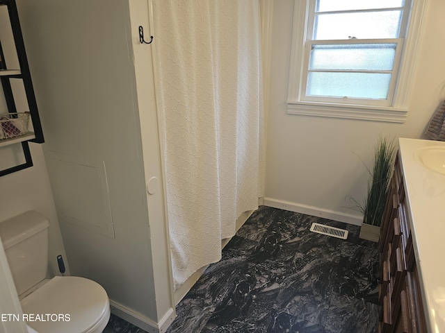 bathroom featuring vanity and toilet