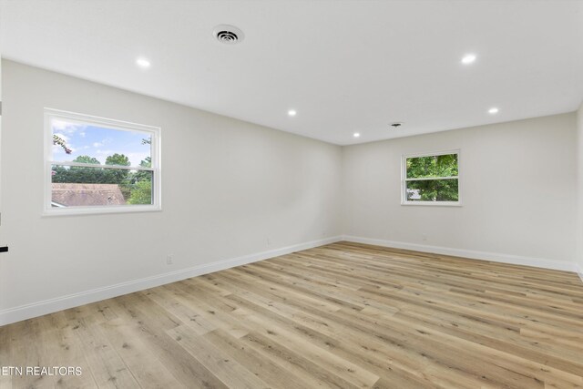 unfurnished room featuring a healthy amount of sunlight and light hardwood / wood-style flooring