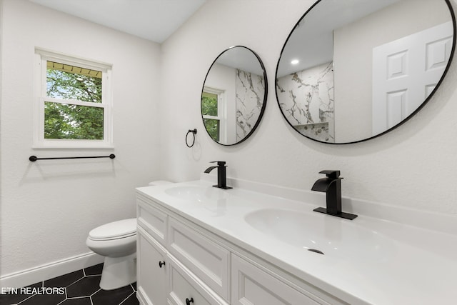 bathroom featuring tile patterned floors, vanity, and toilet