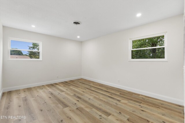 unfurnished room with light wood-type flooring