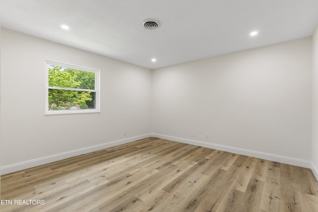 unfurnished room with light wood-type flooring