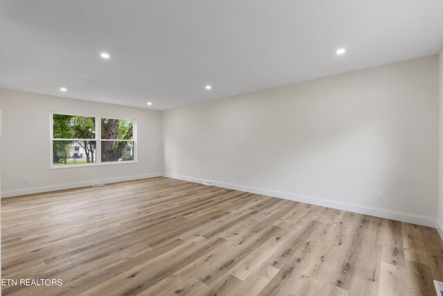 unfurnished room with light hardwood / wood-style floors