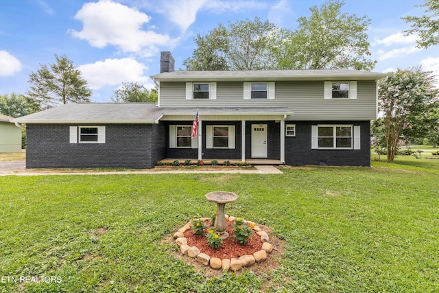 view of property featuring covered porch and a front yard