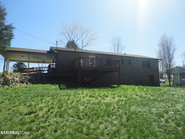 back of house featuring a wooden deck and a lawn