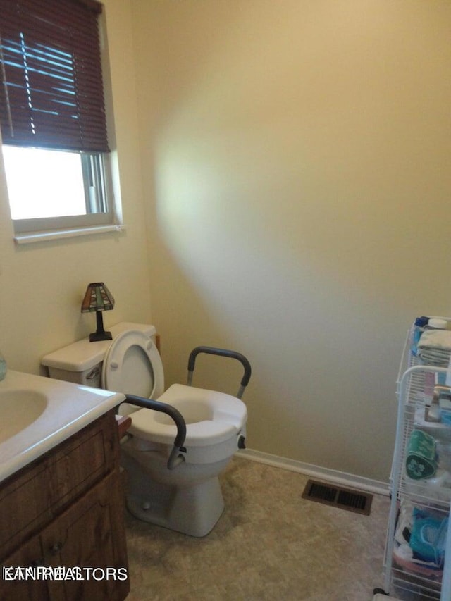 bathroom featuring tile patterned flooring, toilet, and vanity