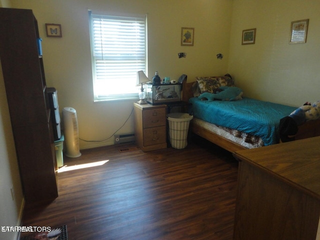 bedroom with dark hardwood / wood-style flooring