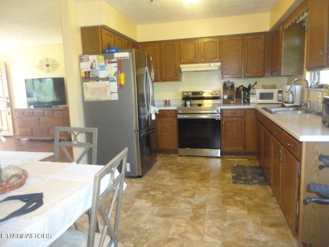 kitchen featuring light tile patterned floors, sink, and stainless steel appliances