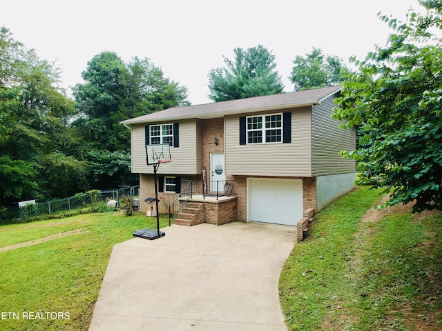 bi-level home with a garage and a front yard