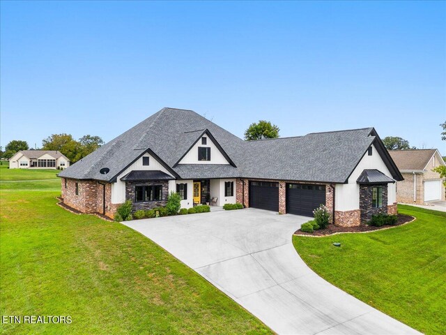 french country style house with a garage and a front yard