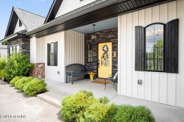 view of exterior entry with covered porch