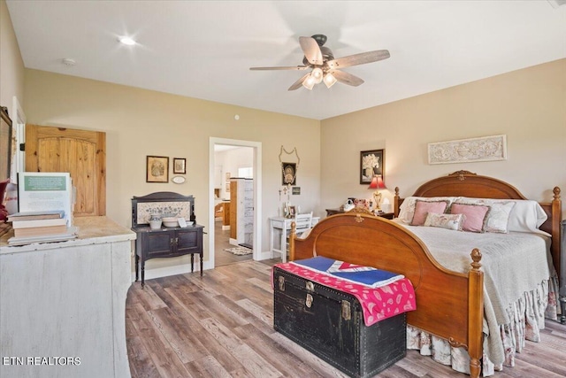 bedroom with ceiling fan, wood-type flooring, and ensuite bathroom