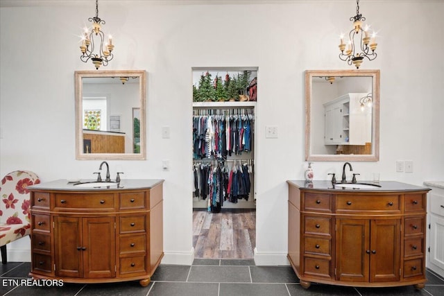 bathroom with vanity, tile patterned floors, and an inviting chandelier